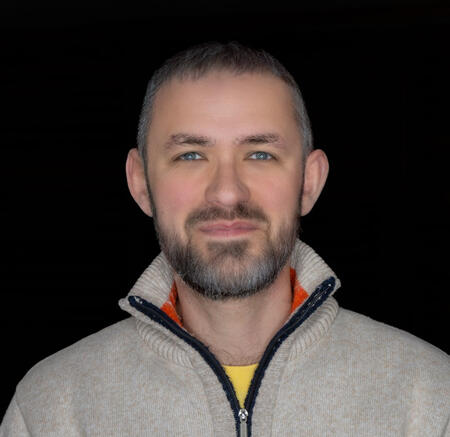 A portrait of Dustin Floyd on a black background.
